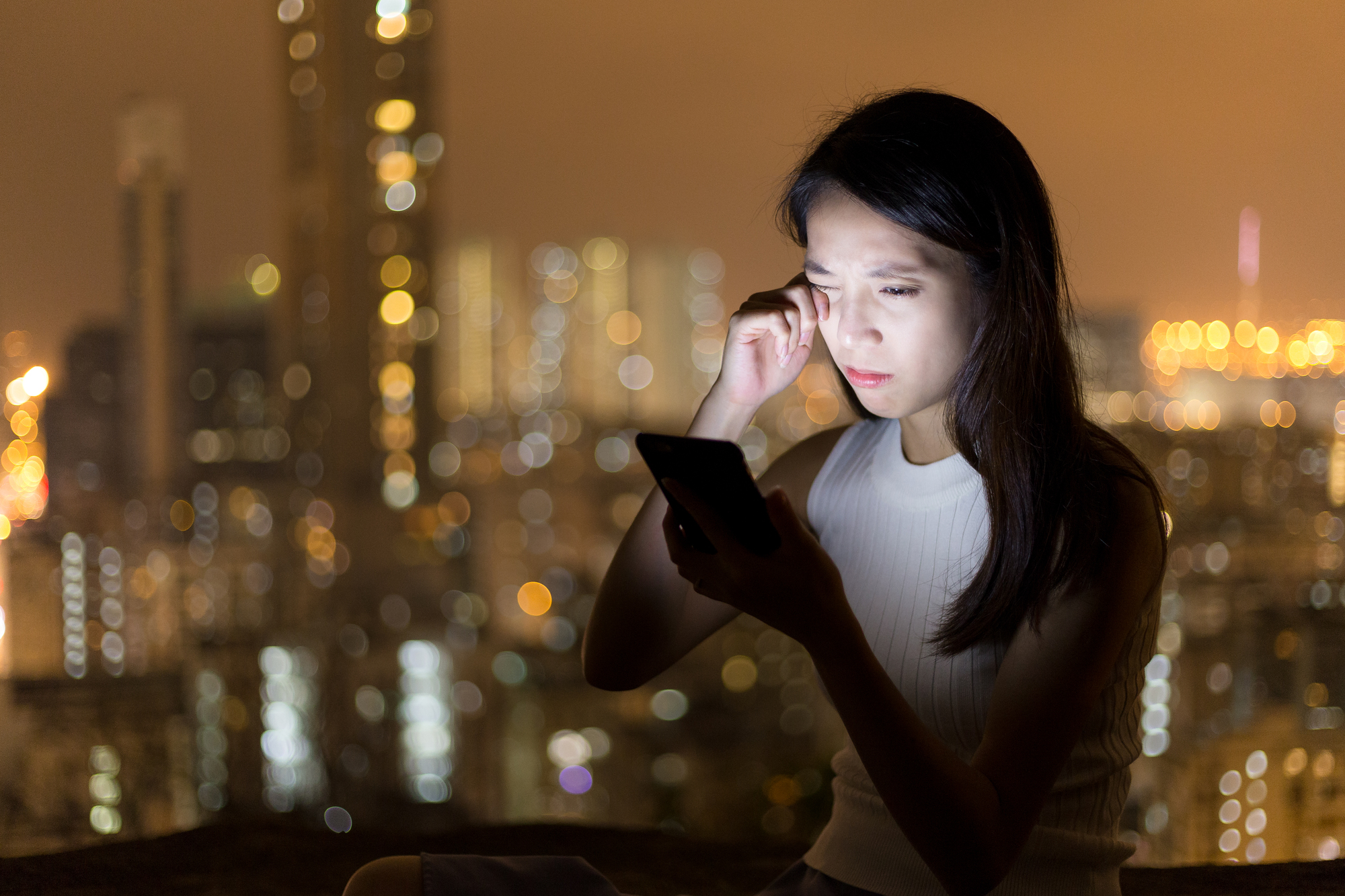 Woman feeling tired when using mobile phone for long